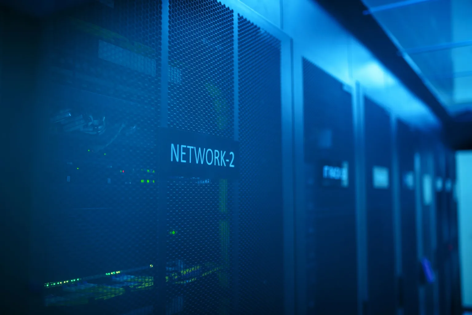 Enterprise network cabinets under blue lighting